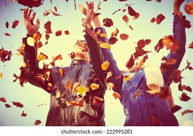 Happy  Couple Throwing  Autumn Fall Leaves