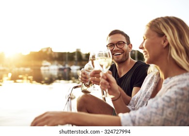 Happy Couple Toasting Glasses On A Summer Evening