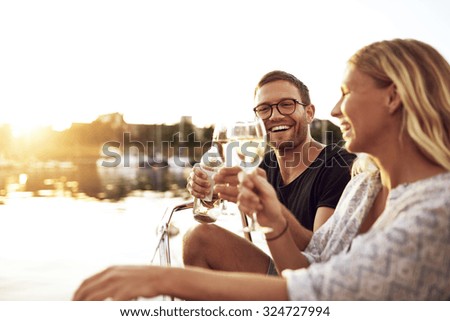 Happy Couple Toasting Glasses on a Summer Evening