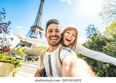 Happy couple of tourists taking selfie picture in front of Eiffel Tower in Paris, France - Travel and summer vacation life style concept - Powered by Shutterstock