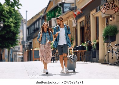 Happy couple of tourists walking in the city while traveling together. Copy space. - Powered by Shutterstock