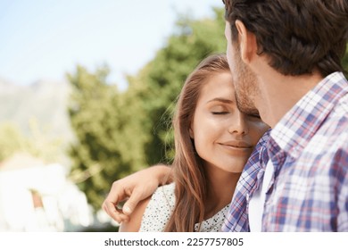 Happy couple, trust or forehead kiss on love date, valentines day or romance bonding in nature, park or relax garden. Smile, woman or man kissing head in intimate security, hug or thank you support - Powered by Shutterstock