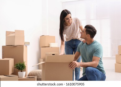 Happy couple unpacking cardboard boxes in their new flat on moving day - Powered by Shutterstock