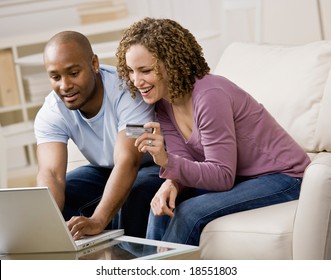 Happy Couple Using Credit Card To Shop Online Conveniently