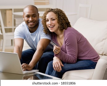 Happy Couple Using Credit Card To Shop Online Conveniently