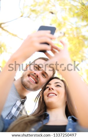 Similar – couple taking selfie in the street