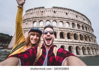 Happy couple visiting Colosseum in Rome, Italy. Friends takes selfie at Coliseum.