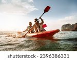 Happy couple walks by sea kayak or canoe at tropical bay