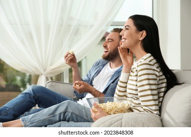 Happy Couple Watching Movie With Popcorn At Home