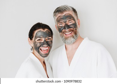 Happy Couple Wearing A Charcoal Mask