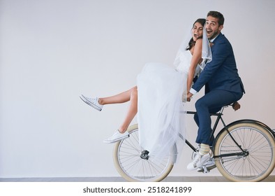 Happy couple, wedding bride and groom on bike for travel, funny laugh or love. Newlyweds, man and woman on bicycle for marriage, excited or celebrate romantic honeymoon on white wall background space - Powered by Shutterstock