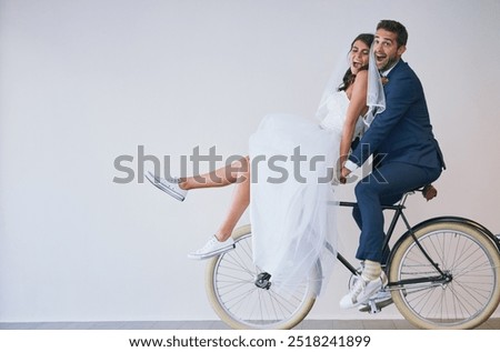 Happy couple, wedding bride and groom on bike for travel, funny laugh or love. Newlyweds, man and woman on bicycle for marriage, excited or celebrate romantic honeymoon on white wall background space