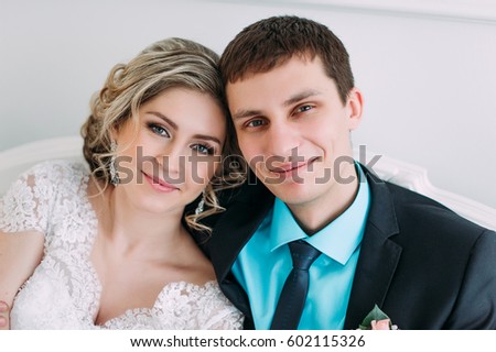 Happy couple. Wedding photo shoot in the white studio with wedding decor kisses, hugs