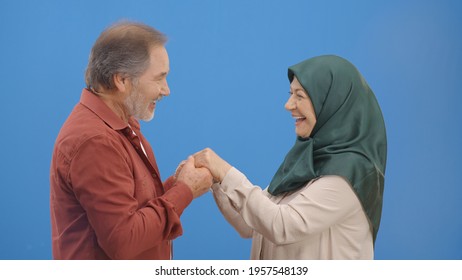 Happy couple who love each other very much. The old couple holding hands, their love doesn't end even after years. Her husband kisses his wife's hands and hugs it with love. 