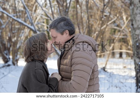 happy couple in winter snowy park