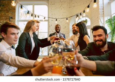 Happy Co-workers Celebrating While Company Party And Corporate Event. Young Caucasian People In Business Attire Cheering, Laughting. Concept Of Office Culture, Teamwork, Friendship, Holidays, Weekend.