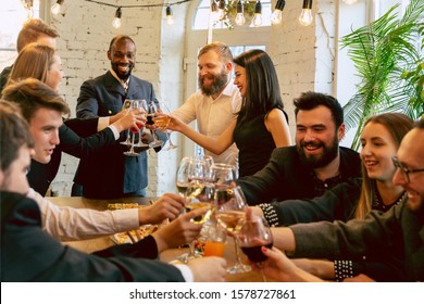 Happy Co-workers Celebrating While Company Party And Corporate Event. Young Caucasian People In Business Attire Cheering, Laughting. Concept Of Office Culture, Teamwork, Friendship, Holidays, Weekend.