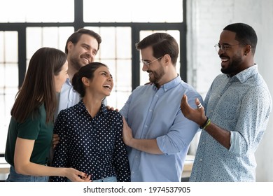 Happy coworkers congratulating excited Indian female employee with hiring or job promotion, welcoming intern to team hugging and cheering. Staff expressing respect and recognition to promoted coworker - Powered by Shutterstock