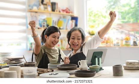 Happy craft pottery shop owners celebrating for sales success after checking order from online shopping on laptop. Online selling, E-commerce concept - Powered by Shutterstock