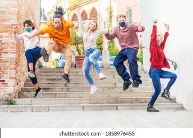 Happy Crazy Friends With Face Mask Jumping Down The Stairs In The City Street In Corona Virus Time - Teenagers Come Out Of School - New Normal Lifestyle Concept -  Main Focus On Blonde Girl