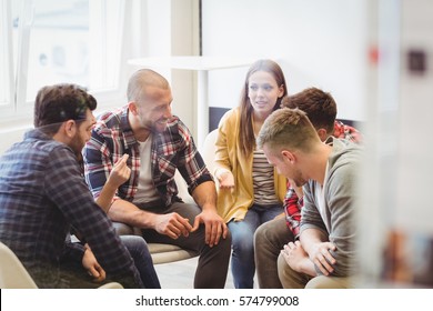 Happy creative business people sitting in meeting room at office - Shutterstock ID 574799008