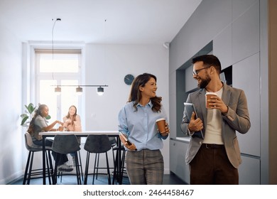 Happy creative colleagues enjoying in coffee break while working in modern office. Copy space. - Powered by Shutterstock