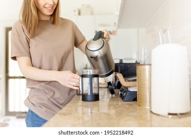 Happy Cropped Young Woman Making Coffee In Kitchen - French Press Coffee. Caucasian Female Model In Her Twenties At Home Kitchen. Lifestyle Concept