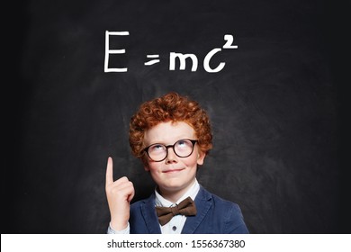 Happy curious kid little boy genius on blackboard background - Shutterstock ID 1556367380