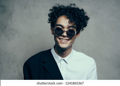 Happy Curly Man In A Suit And Sunglasses                       