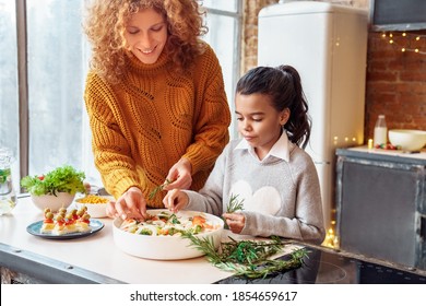 Happy Curly Woman And Mixed Race Girl Niece Making Healthy Vegan Salad And Snacks For Family Feasting. Christmas, New Year, Thanksgiving, Anniversary, Hanukkah, Mothers Day, Easter, Engagement Concept