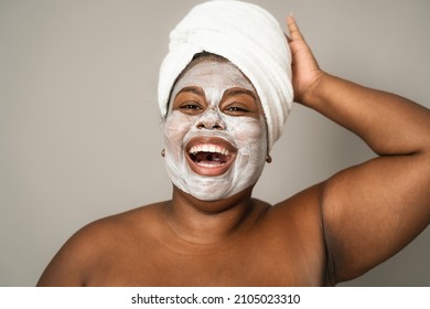 Happy curvy African woman having skin care spa day - People self care lifestyle concept - Powered by Shutterstock