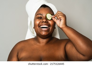 Happy curvy African woman having skin care spa day - People self care lifestyle concept - Powered by Shutterstock