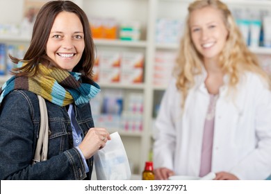 Happy Customer With A Pharmacist In A Pharmacy