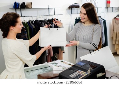 Happy Customer With Shopping Bag In Fashion Showroom 