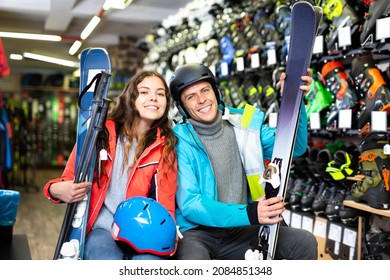 Happy customers are demonstrating their choice of boots for skiing in sport shop