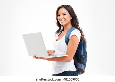 Happy Cute Asian Student Girl With Backpack Standing And Holding Laptop Isolated On A White Background