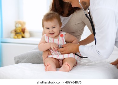 Happy Cute Baby With Her Mother At Health Exam At Doctor's Office. 