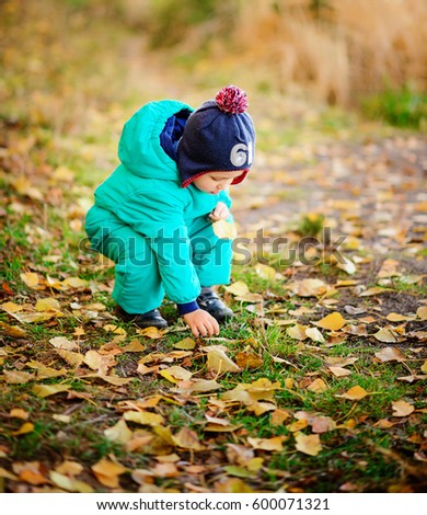 Similar – Image, Stock Photo Sun always shines after the rain. Small bond infant boy wearing yellow rubber boots and yellow waterproof raincoat walking in puddles in city park on sunny rainy day.