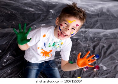 Happy Cute Boy Colors His Hands. Doing Finger Painting. Art Therapy For Children. Psychology Of The Child's Personality. Help Gaining Confidence. Drawing. Creativity And Education Concept.