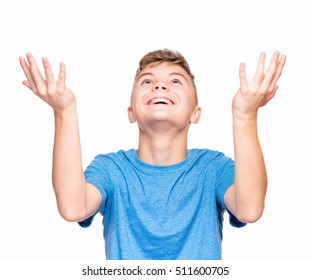 Happy Cute Child Reaching Out His Palms And Catching Something. Half-length Emotional Portrait Of Caucasian Teen Boy Wearing Blue T-shirt, Surprised. Funny Teenager Trying To Catch Something, Isolated