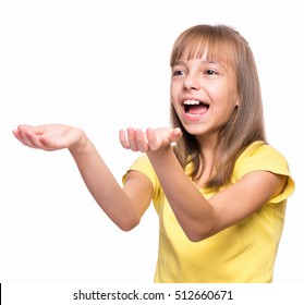 Happy Cute Child Reaching Out Her Palms And Catching Something. Half-length Emotional Portrait Of Caucasian Little Girl Wearing Yellow T-shirt, Surprised. Funny Kid Trying To Catch Something, Isolated