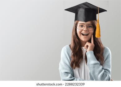 Happy cute child student wearing graduate cap - Powered by Shutterstock