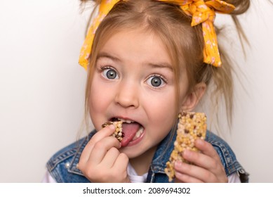 Happy Cute Girl Eats A Fruit Bar, Healthy Muesli Snack, Quick Snack