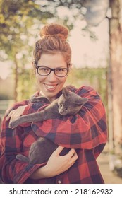 Happy Cute Hipster Girl Being Silly And Playing With Her Russian Blue Cat