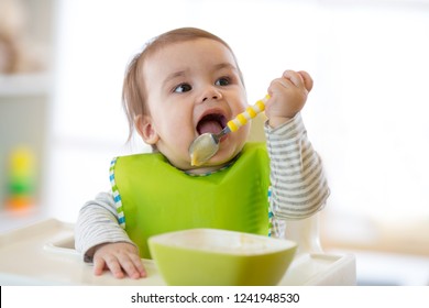 Happy Cute Infant Baby Boy Spoon Eats Itself