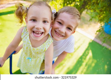 Happy Cute Kids Having Fun At Playground