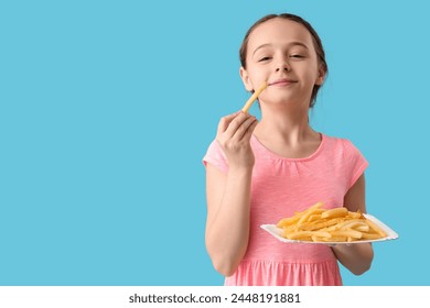 Happy cute little girl with plate of french fries on blue background - Powered by Shutterstock