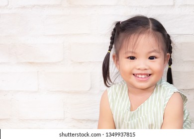 Happy Cute Little Girl ; Portrait Of Glad, Smiling, Positive Asian Child.