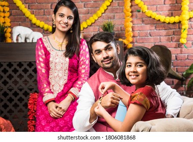 Happy Cute Little Indian Girl Celebrating Rakshabandhan Or Rakhi Festival With Big Brother