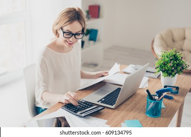 Happy cute  pretty accountant working with computer and calculator. - Shutterstock ID 609134795